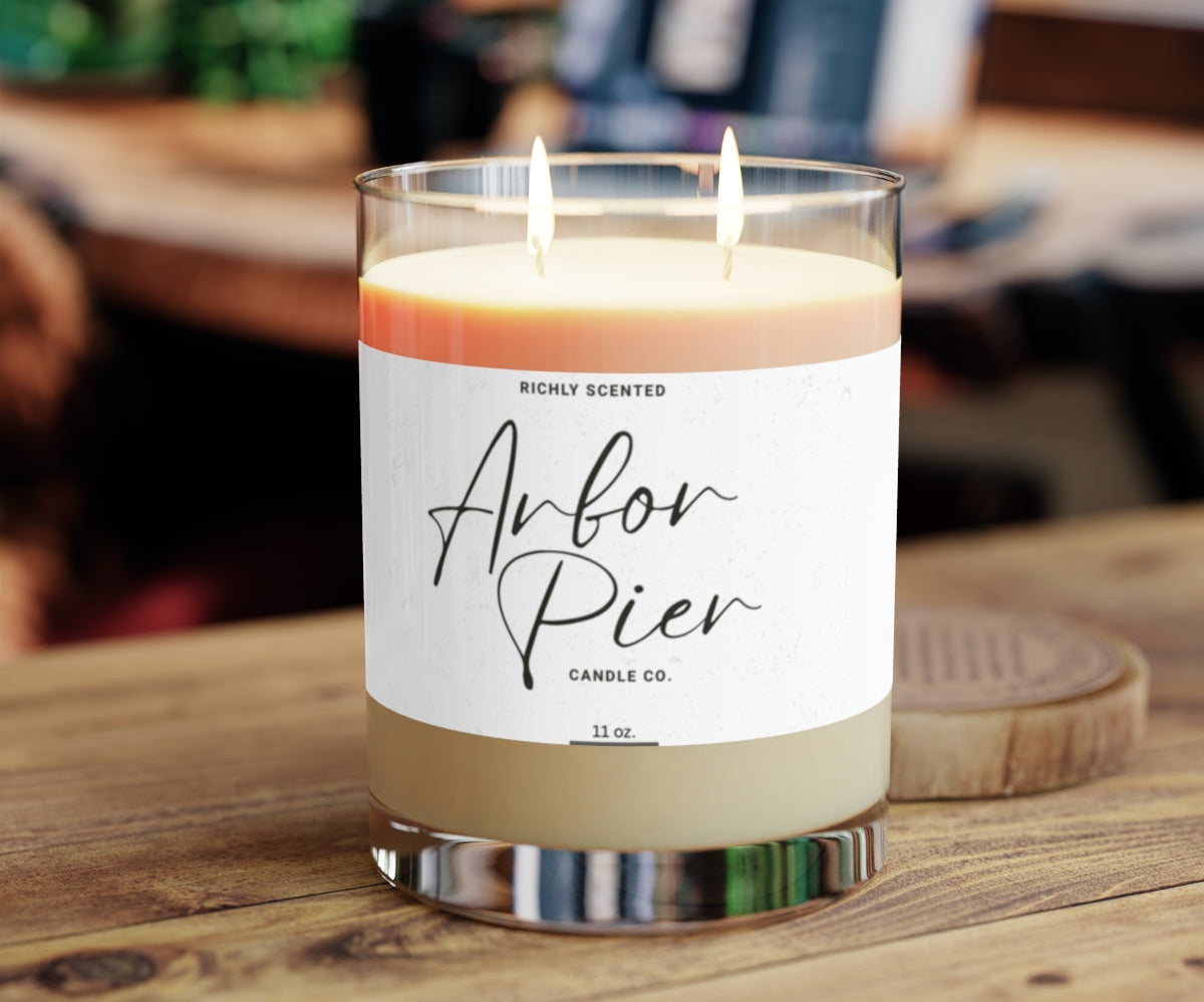 Candle with a label on a wooden surface, blurred background