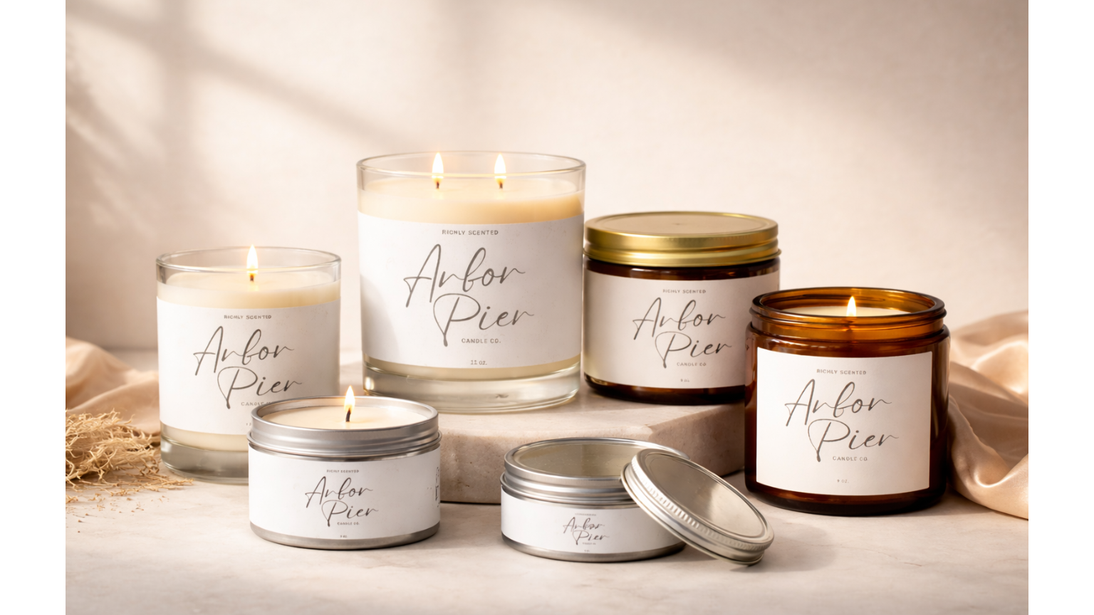 Collection of candles and containers with 'Auror Pier' branding on a neutral background